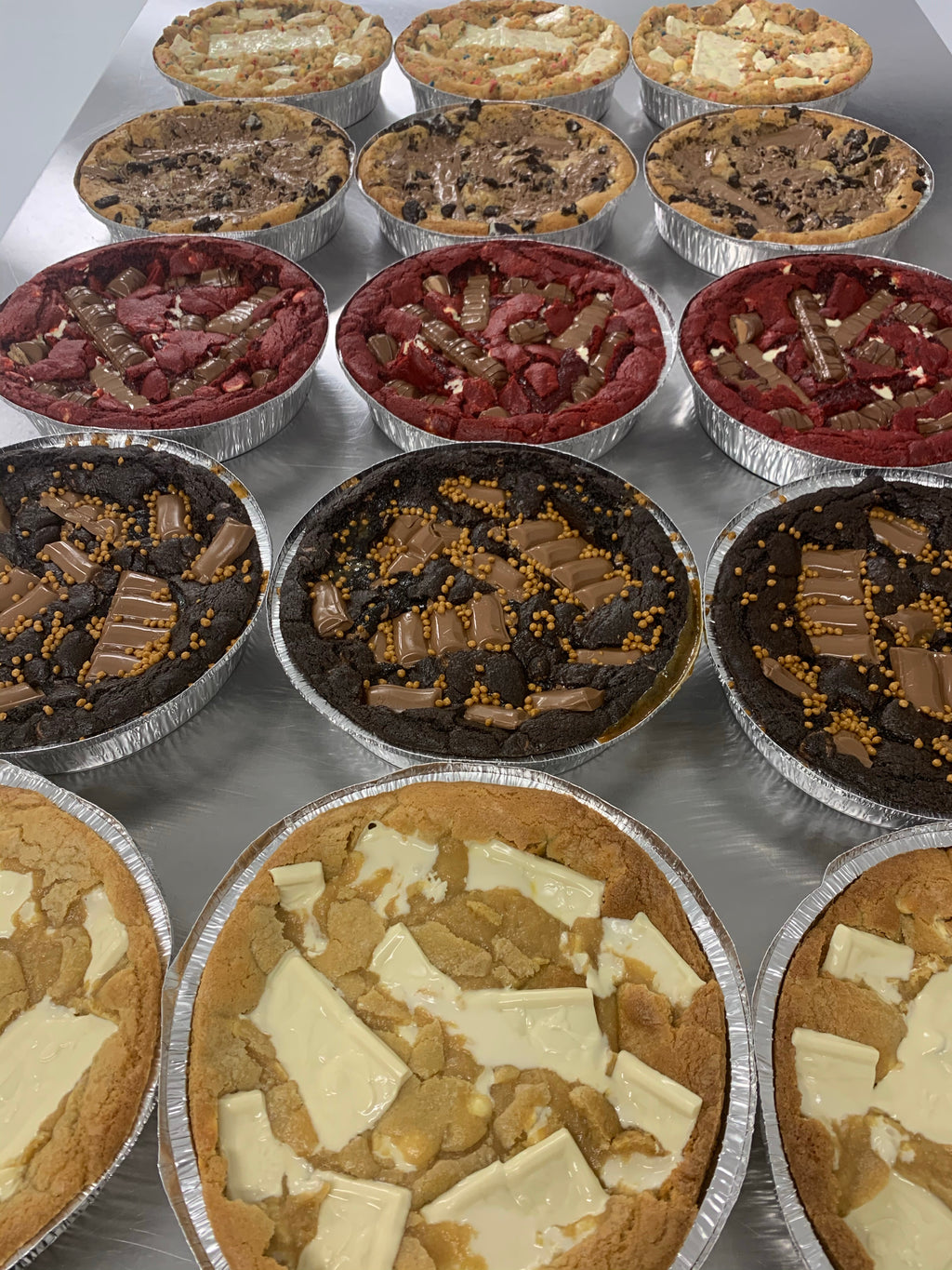 a selection of prepared cookie pizzas