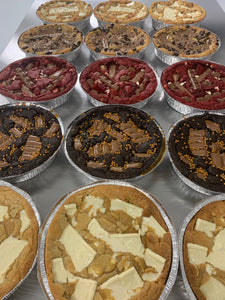 a selection of prepared cookie pizzas